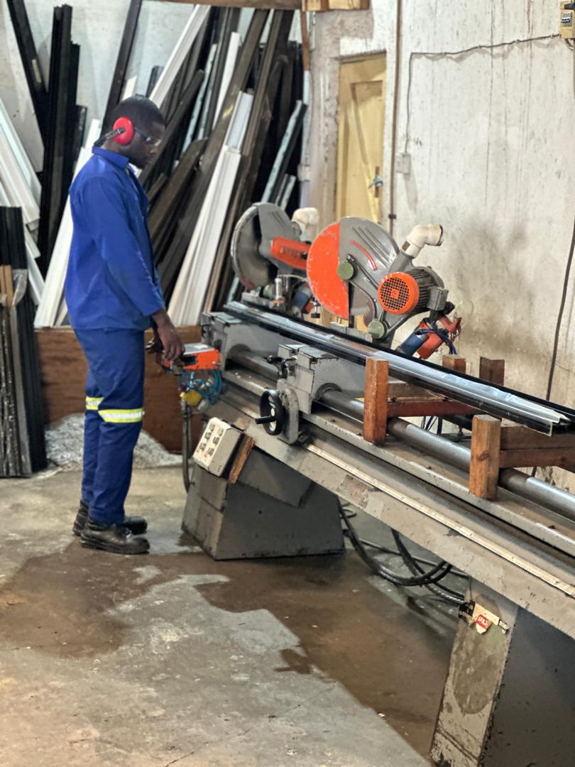RDH Glazing workshop technician cutting aluminium profile