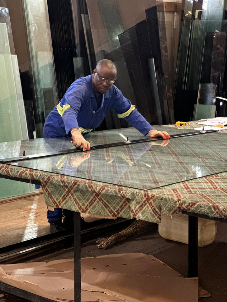 RDH technician working with glass panels